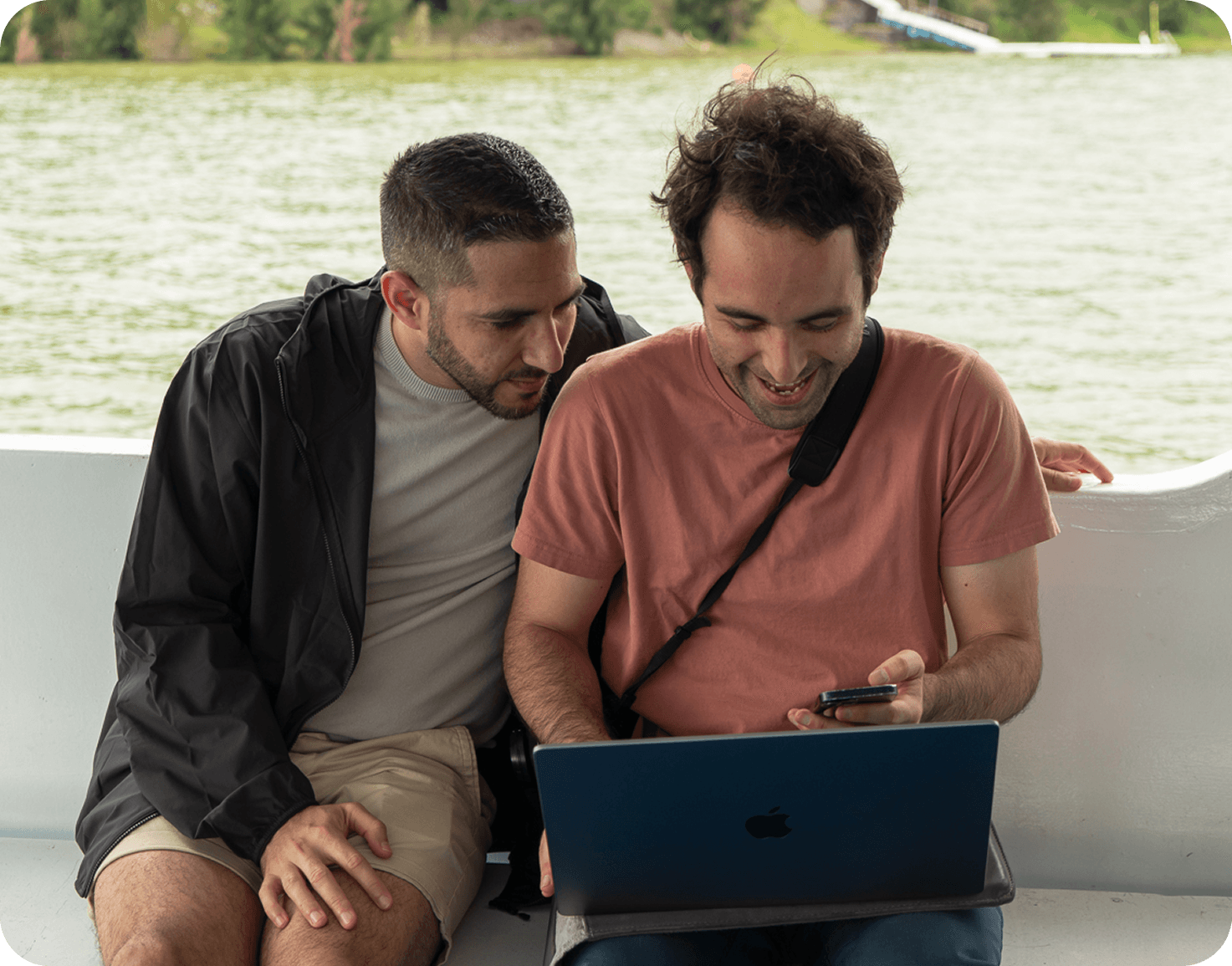 Two Nelo team members collaborating on a laptop
